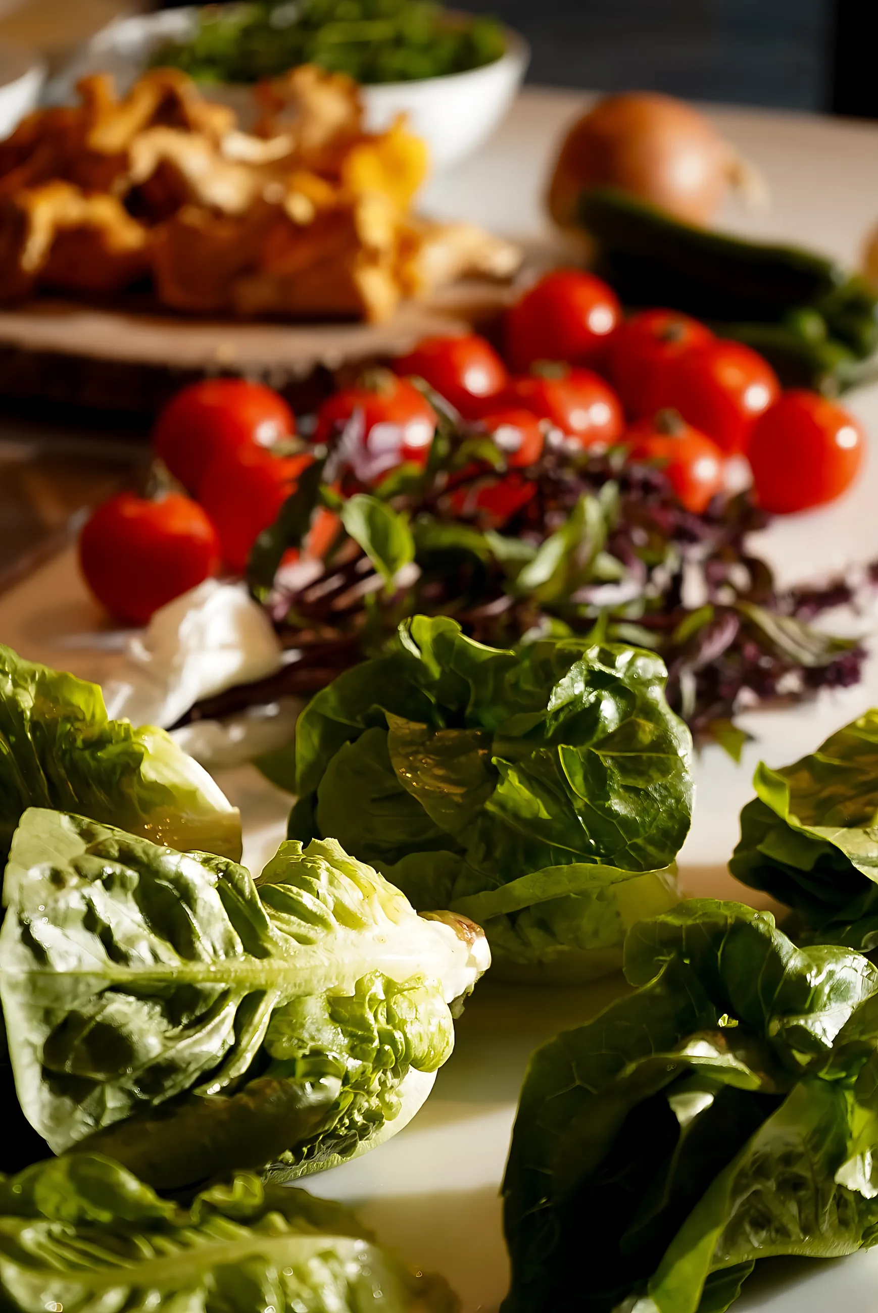 Little gem lettuce, tomatoes and herbs on the counter